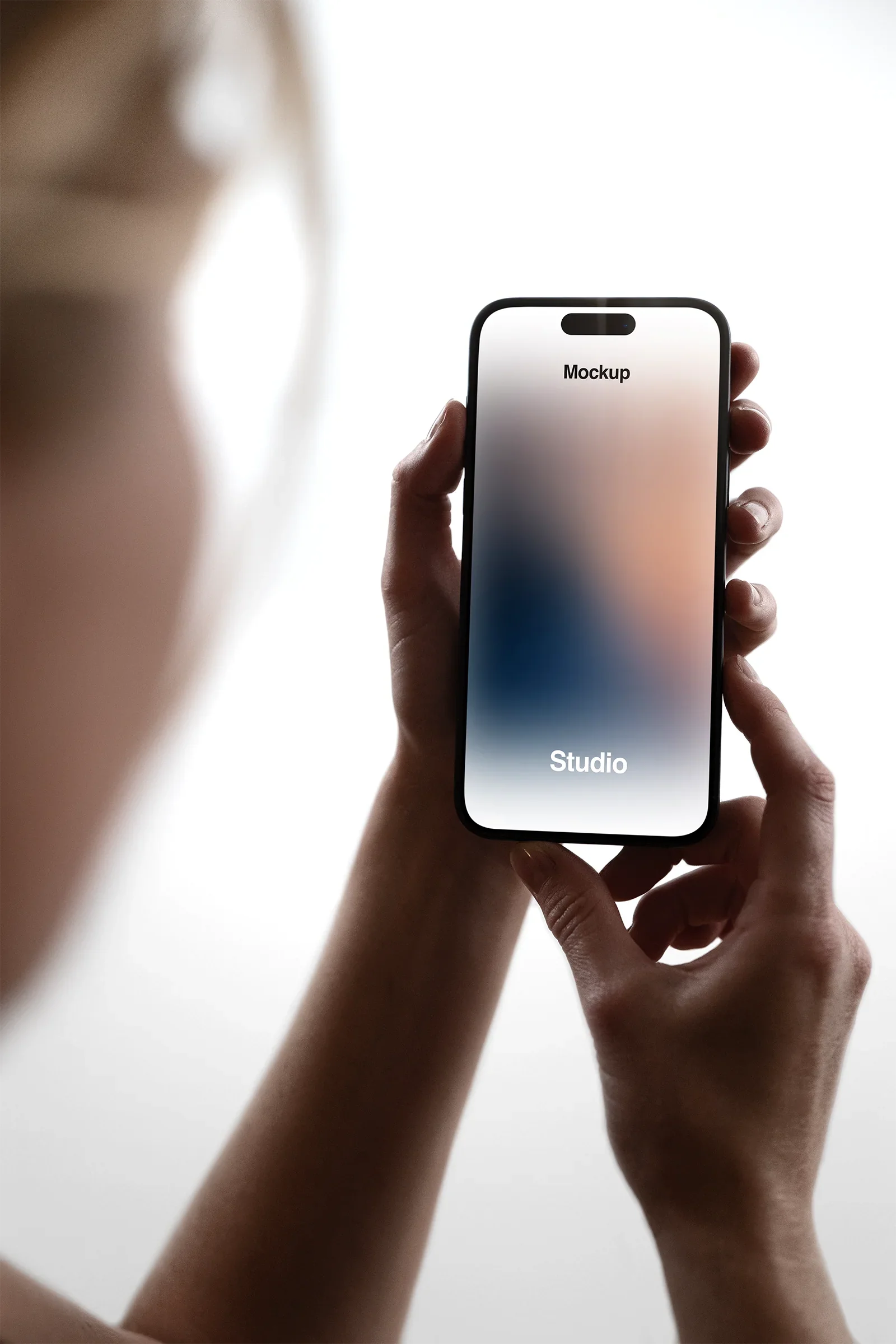 Handheld iPhone Mockup in a photo studio in New York - BRANDACLE