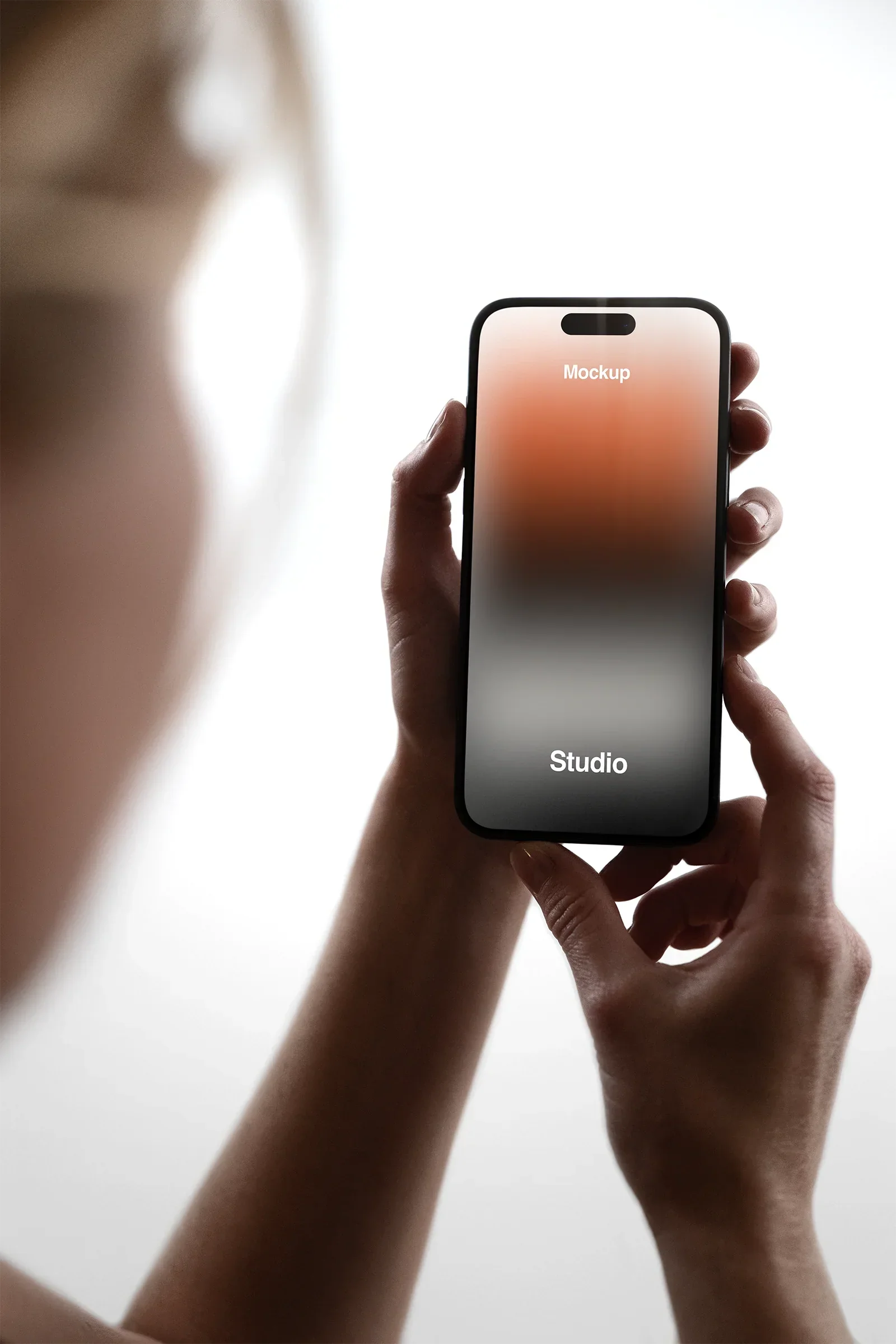 Handheld iPhone Mockup in a photo studio in New York - BRANDACLE
