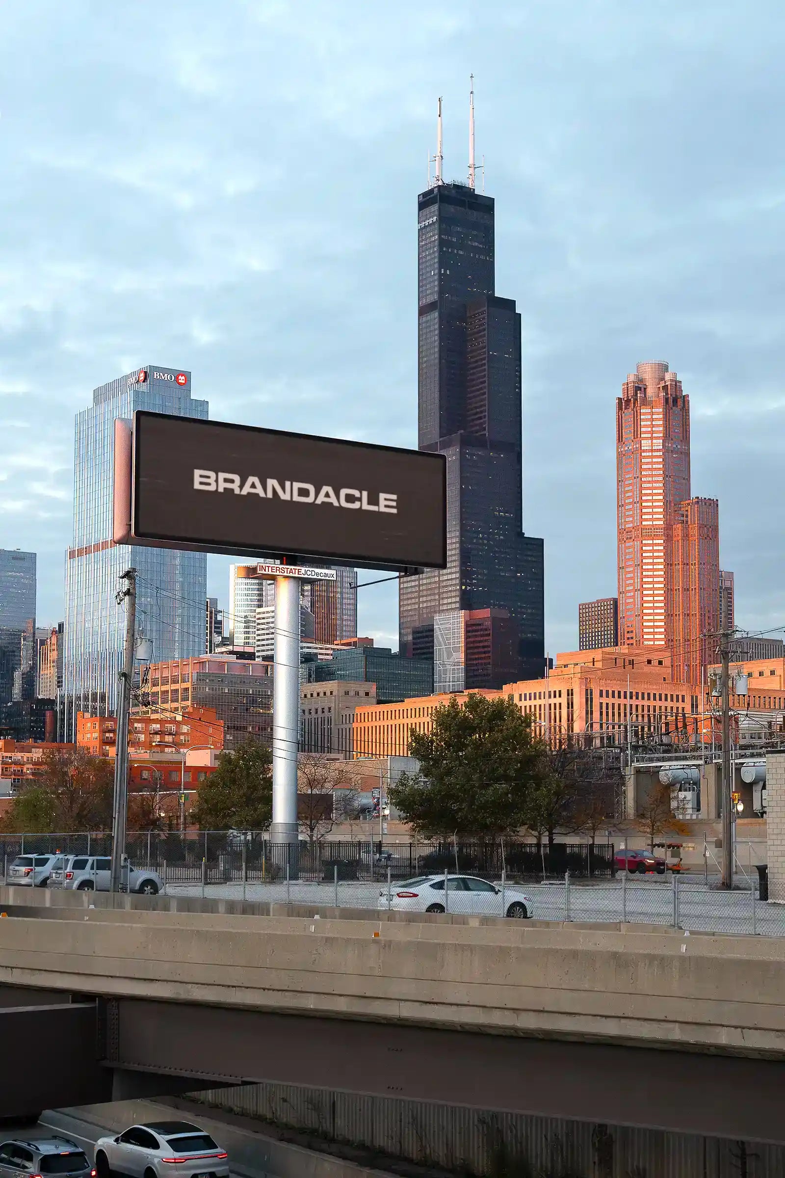 Billboard mockup by the highway in Chicago, United States, in front of the Sears Tower. 