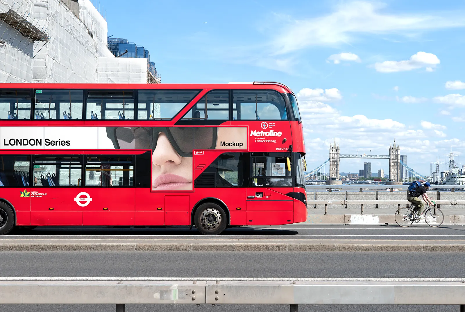 Red bus poster mockup against the backdrop of the iconic Tower Bridge in Central London © BRANDACLE MOCKUPS 2026.