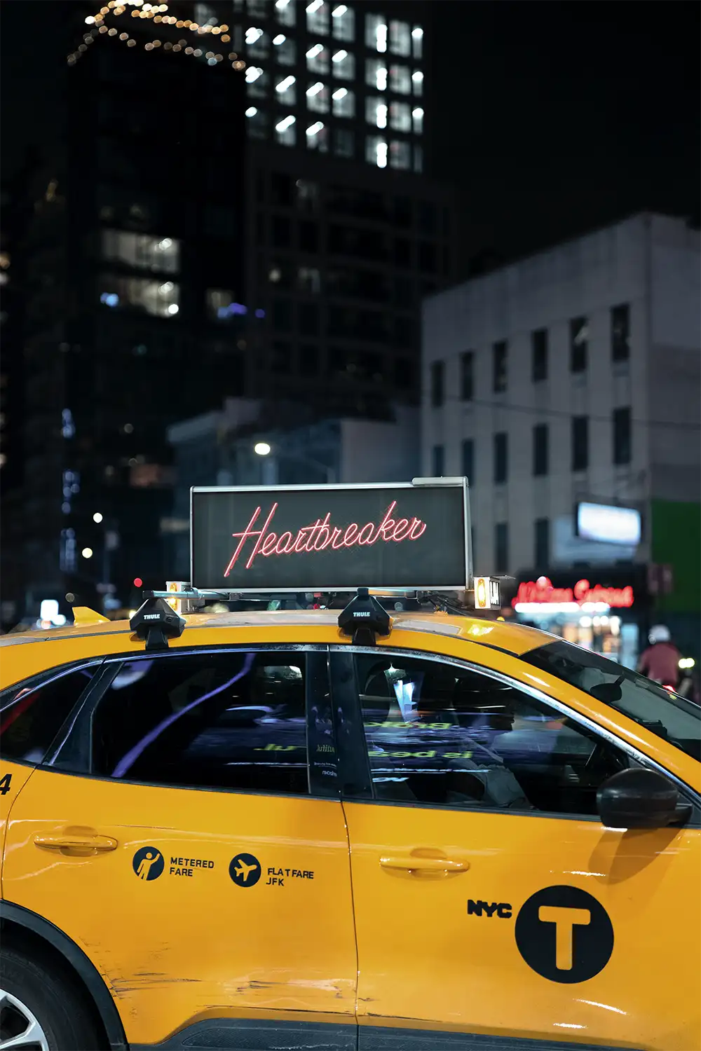 Digital billboard on a yellow cab taxi on Times Square in New York